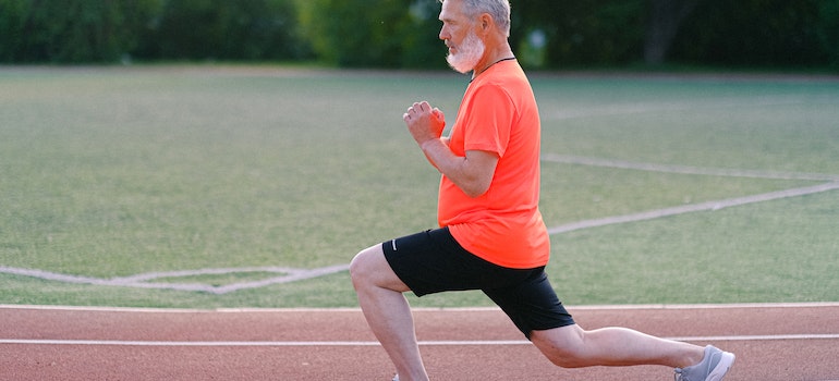 An older man exercising on a track
