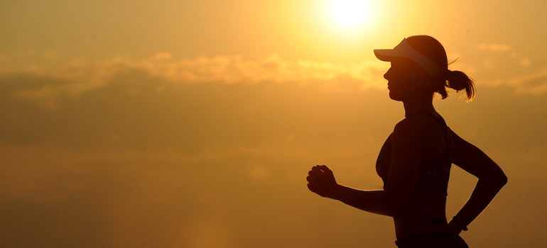 A silhouette of a woman running at dusk representing how improved mobility boosts performance