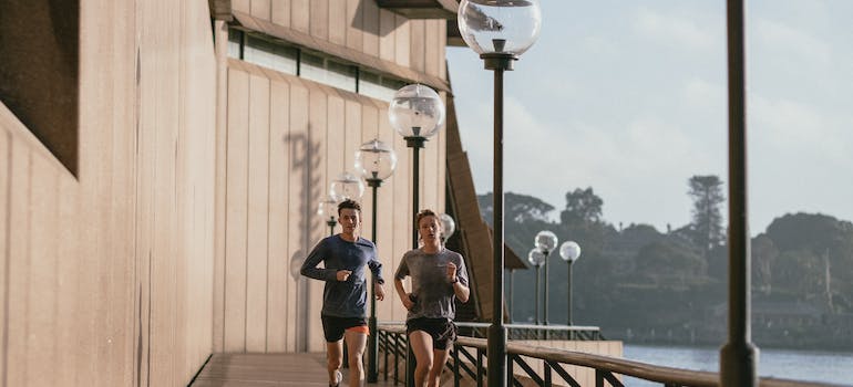 A fitness trainer fujairah running with a client outside 