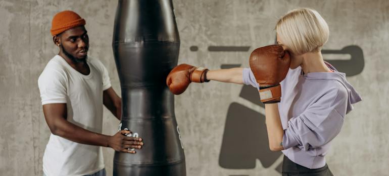 woman attending a boxing class after she learned how to pick the right personal trainer in the UAE