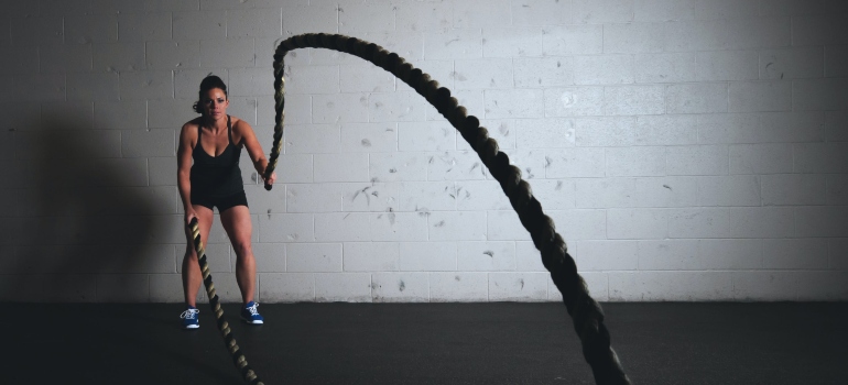 A woman exercising with ropes