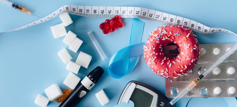 A measurement tape and a scale on a desk with a donut.