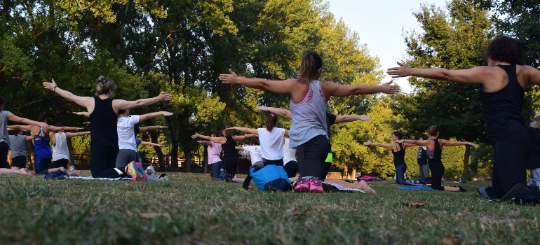 People in the park practicing yoga. 