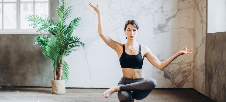 A woman holding a yoga pose. 