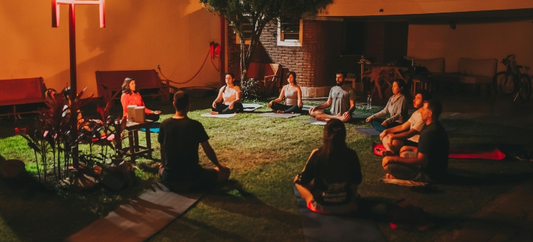 People doing yoga in the evening. 