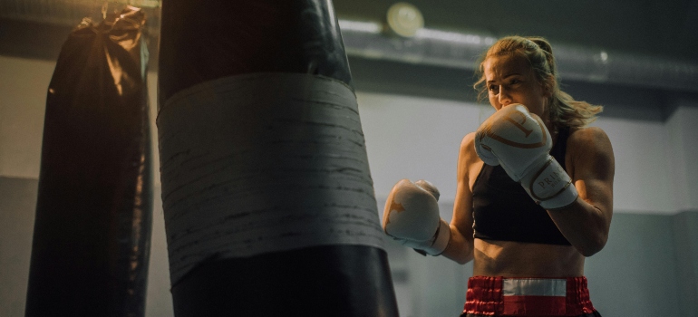 A woman boxing in the gym.