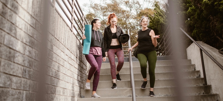 Three women going to the gym happy.