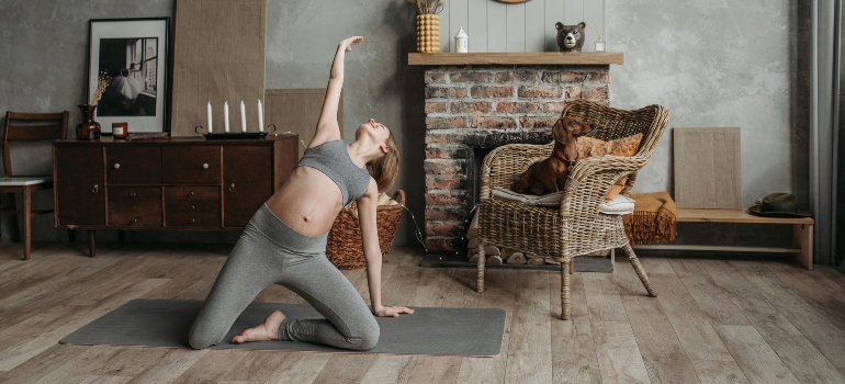 A woman doing yoga in her apartment. 
