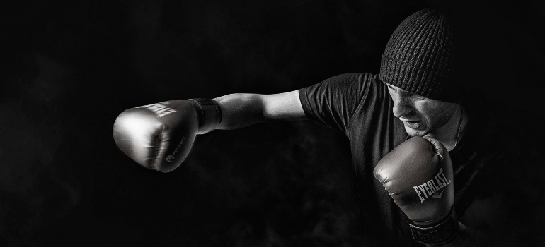 A person boxing to deal with stress management through fitness in Sharjah.