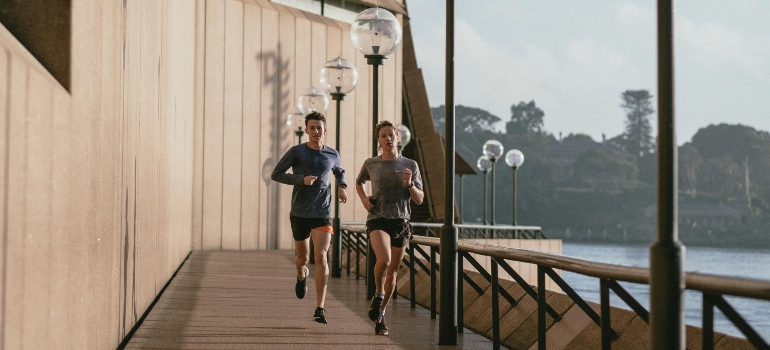 people jogging besides a river. 