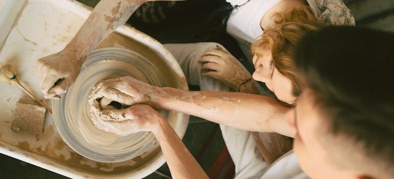 A couple participating in a pottery session.