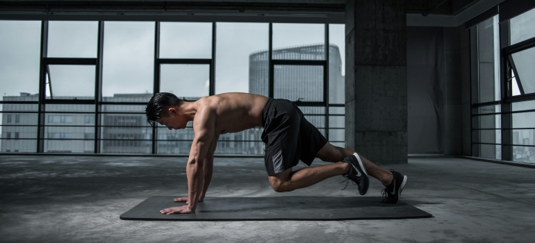 a man doing an exercise that is a part of circuit training workouts