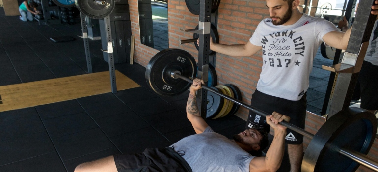 a man doing bench presses at a gym