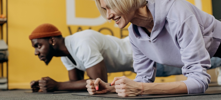 A man and a woman doing push ups