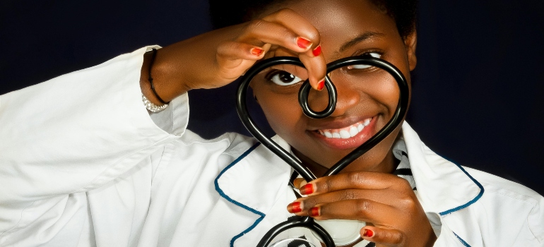 a doctor holding a stethoscope in a shape of a heart