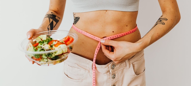 A woman checking if she lost weight 