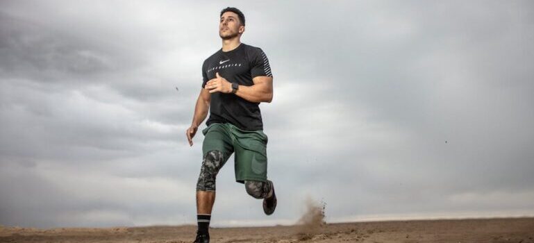 A man running on sand field