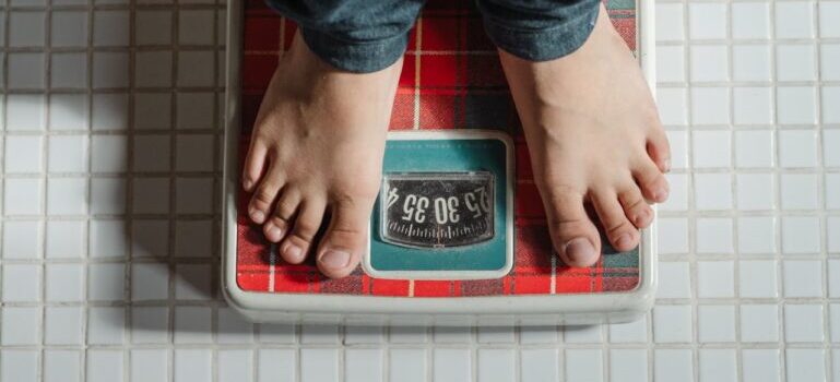 A person weighing on scale