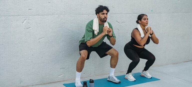 A man and woman doing squats