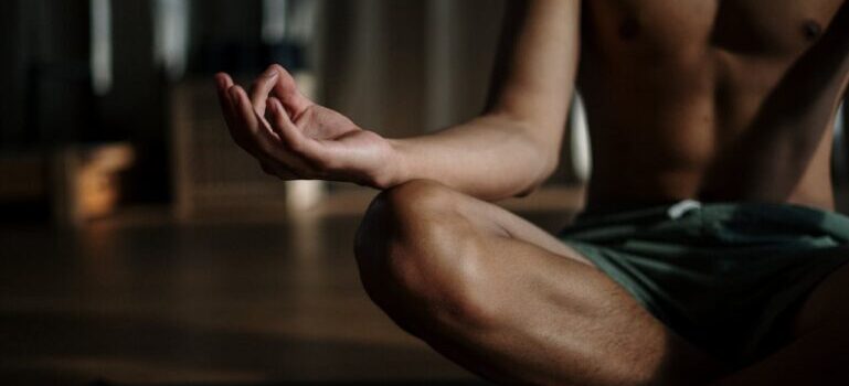 A man in black shorts practicing yoga