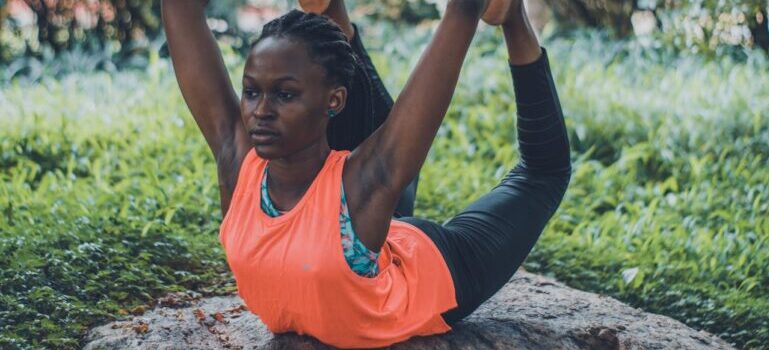 A woman doing yoga on a rock