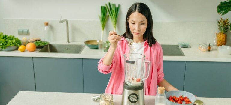 A woman preparing meal after adjusting to evening weight loss routines in Dubai