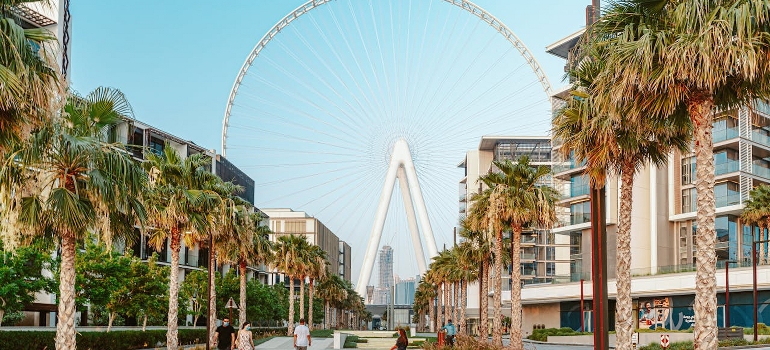 A white ferris wheel under the blue sky.