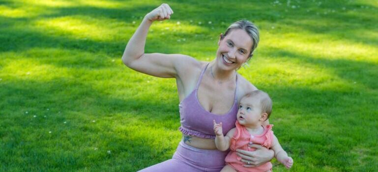 A woman and a baby on green grass