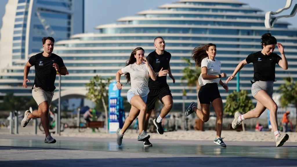 FitForce coaches and clients, outdoor running session at Umm Suqeim beach with Burj Al Arab, Dubai
