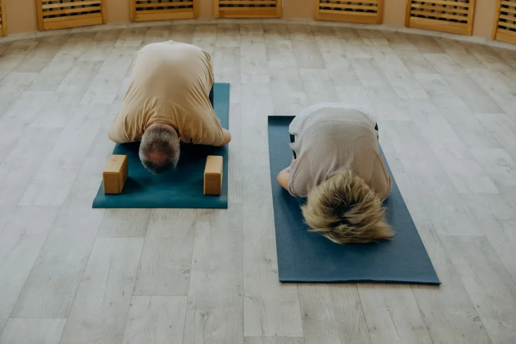 Two people doing yoga as a part of couples wellness and spa retreats in Abu Dhabi