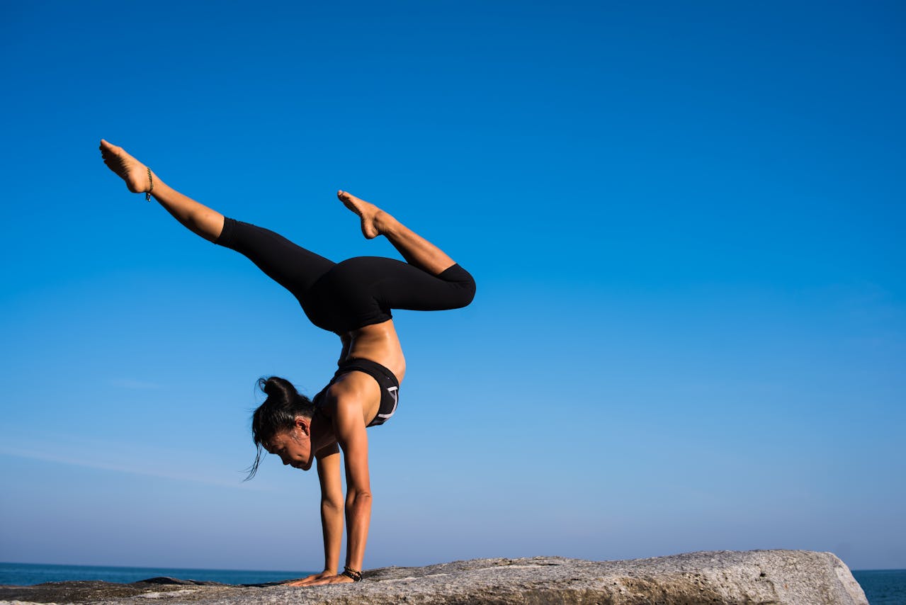 A woman practicing yoga in one of the best outdoor yoga spots in Sharjah