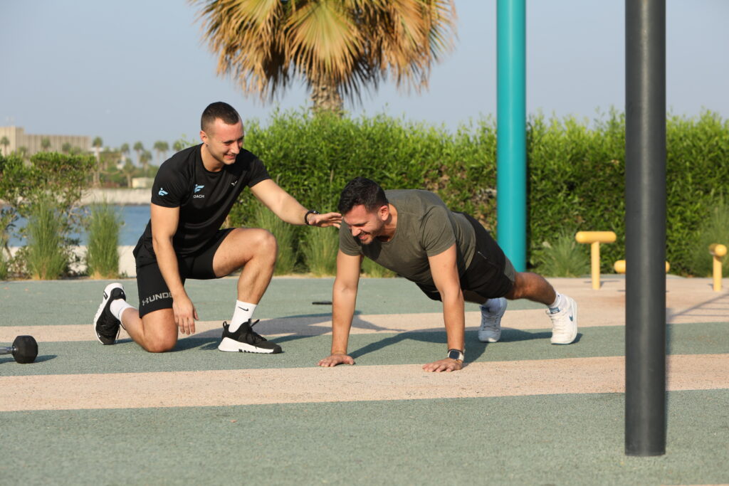 A man doing pushups, who represents hiring weight loss coach UAE