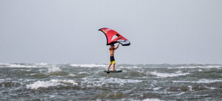 An Adventurous Man Wind Surfing on the Beach