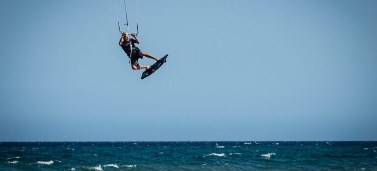 man kitesurfing and jumping