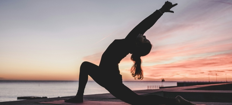 Person combining yoga and proper nutrition in injury recovery in Umm Al Quwain