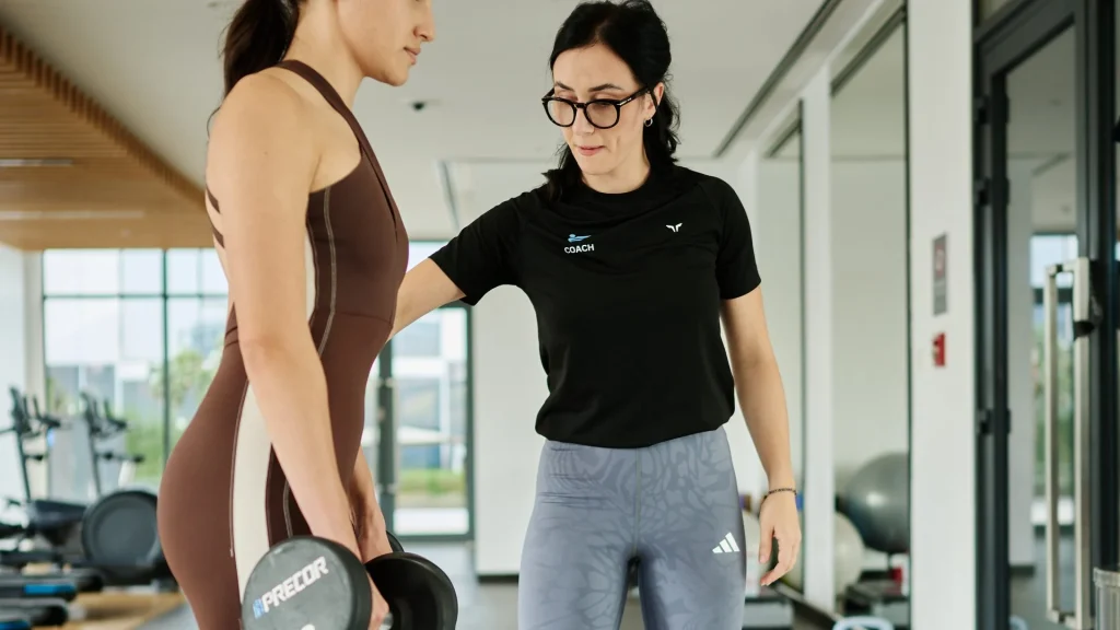 Violeta, female personal trainer, session with a client in a Dubai building gym