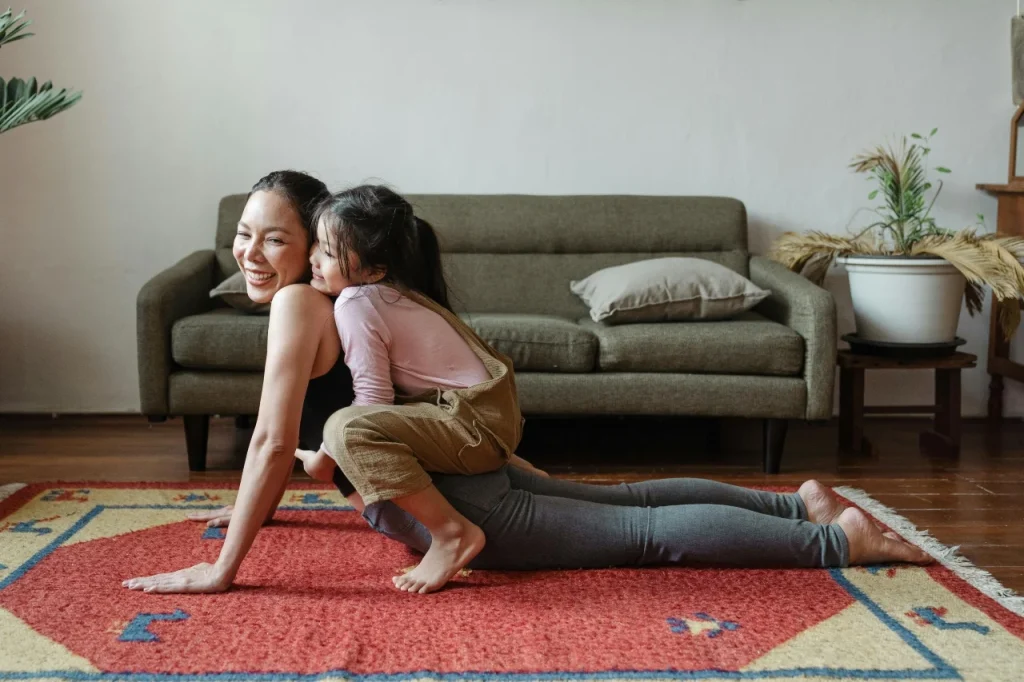 a mother and a child stretching home