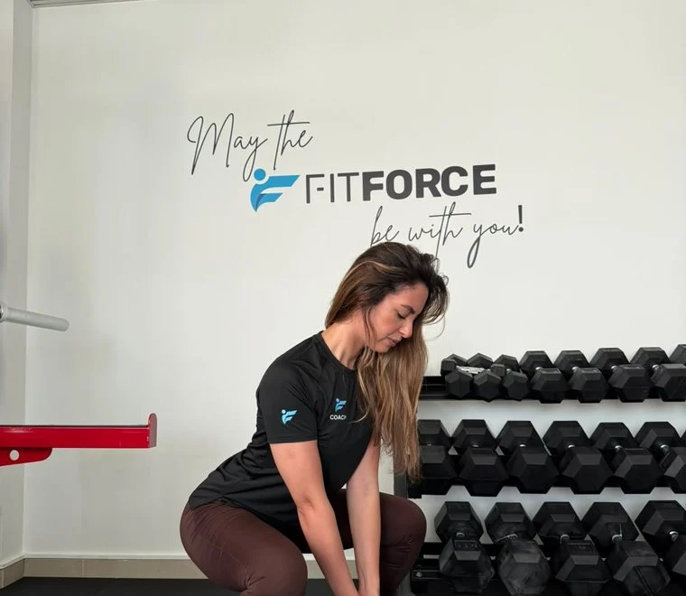 Mery, female personal trainer at FitForce Dubai, dumbbell squat