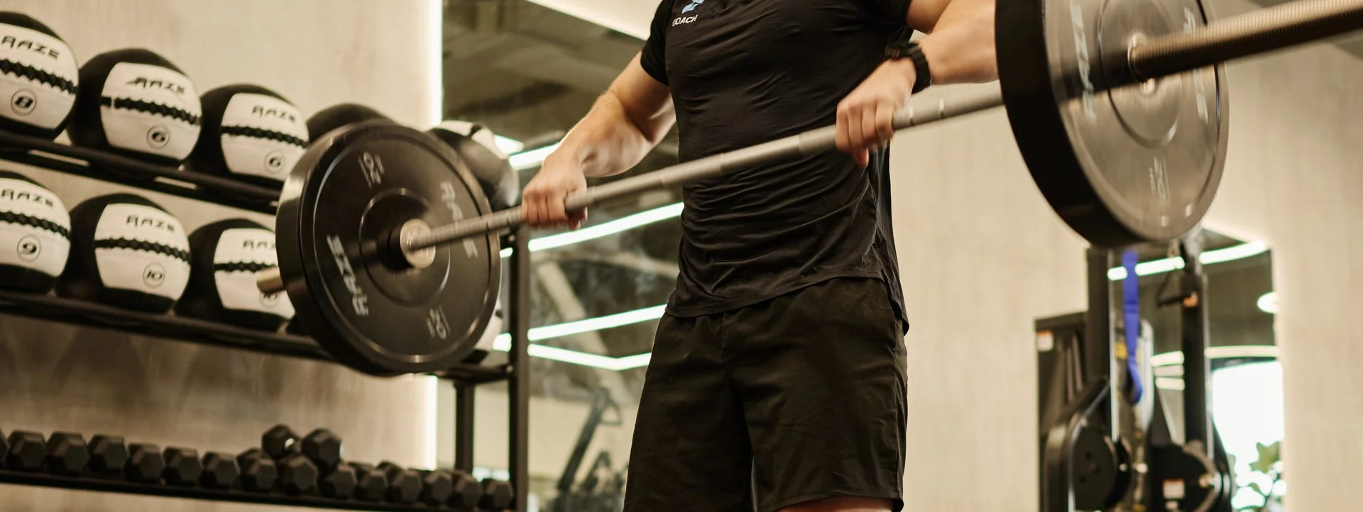 Tony, personal trainer, barbell lift in a Dubai strength gym