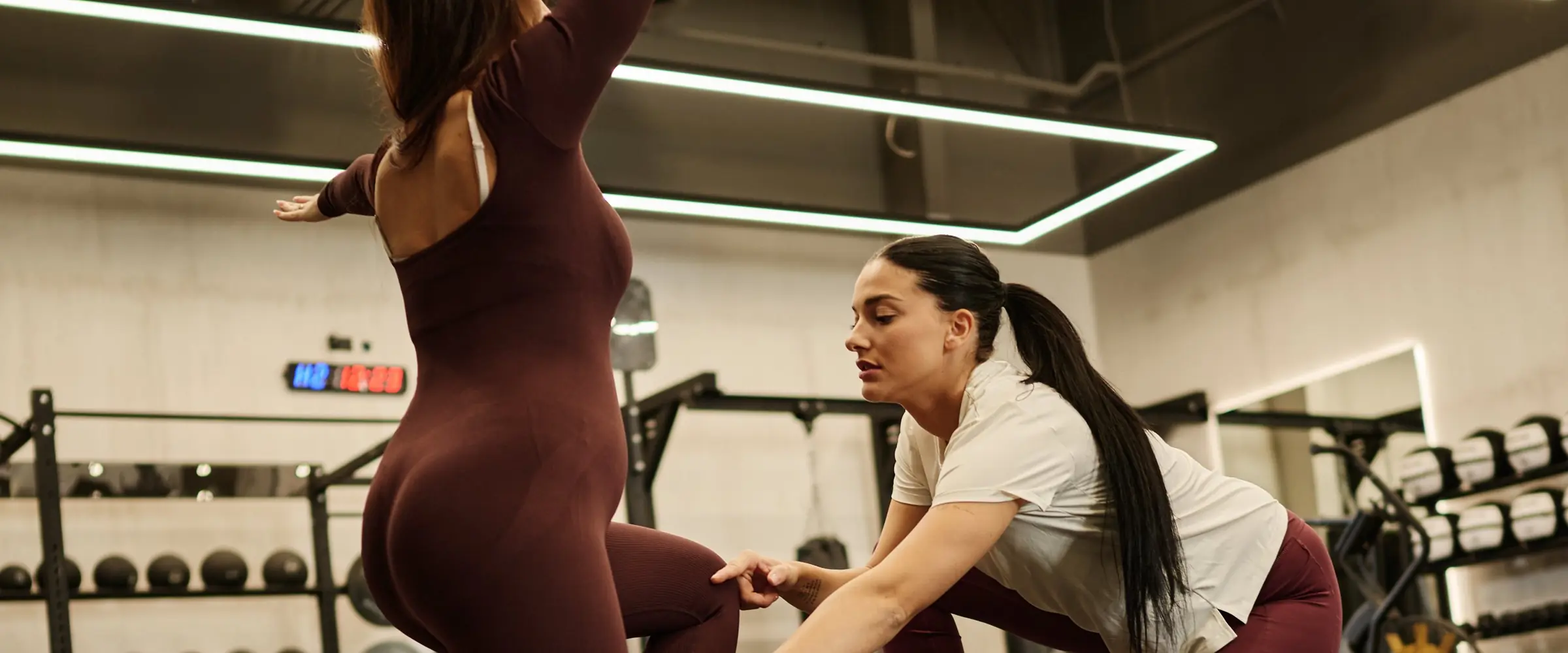 Katarina, personal trainer, coaching a client's cable lunge during a strength session in Dubai